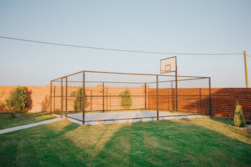 gated basketball court in backyard