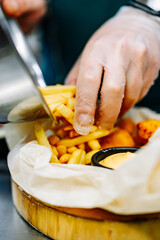 chef cooking Chicken Nuggets with French Fries and sauce on kitchen