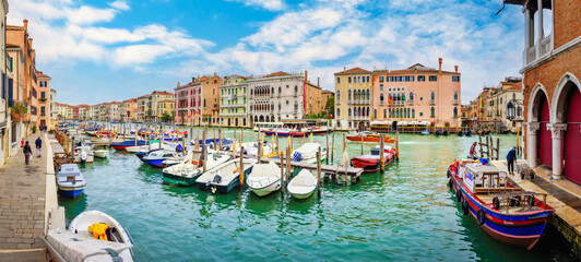 VENICE, Italy - September 30, 2022: View of the Grand Canal with boats on a sunny summer day. Old houses along the canal.
