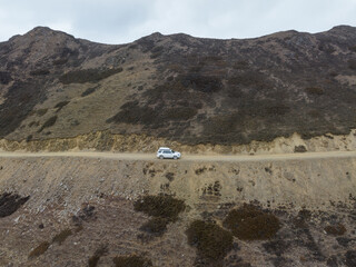 Aerial view driving car on high altitude mountain trail, China © lzf
