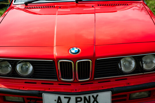 Earsham, Norfolk, UK – April 30 2023. Close up of the front end including bonnet, badge, grille and headlights of a classic series 3 BMW saloon car on display at an outdoor car show