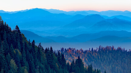 Beautiful landscape with cascade blue mountains at the morning - View of wilderness mountains during foggy weather