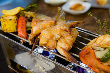 Beef and salmon fin skewers BBQ grilled served on restaurant.