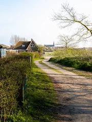 Fototapeten a path leading in the direction of a farm and church egmond © Evelien