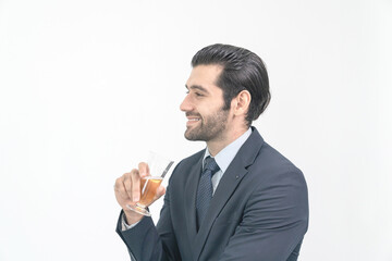 Portrait smiling businessman  wearing suit standing and holding a glass of champagne on white background.