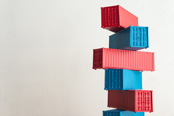 Blue and red containers model stacked with white wall background copy space. Concept of GDP global world economy, import export industrial, goods production, manufacturing, cargo shipping logistics.
