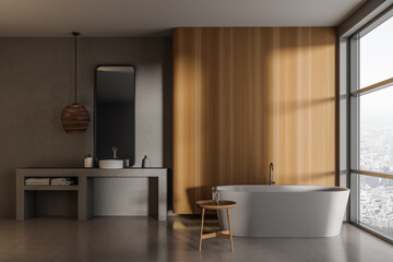 Fototapeta na wymiar Grey bathroom interior with sink and bathtub near panoramic window. Empty wall