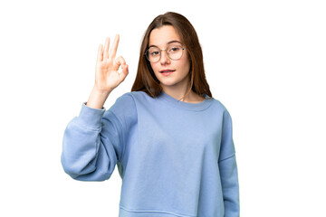Teenager girl over isolated chroma key background showing ok sign with fingers