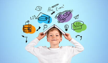 Smiling boy with book on head, education icons doodle on blue ba