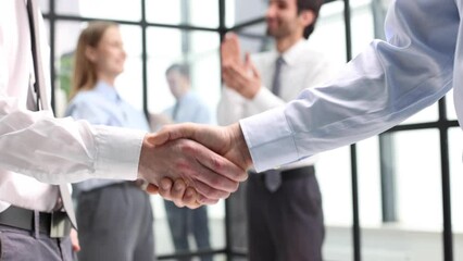 composite of Business people shaking hands against blurred background - Powered by Adobe