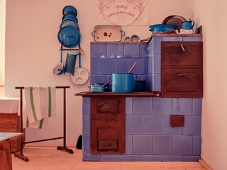 A beautiful old stove in blue design with dishes