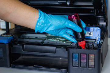 Technicians Refill ink cartridges, printer Inkjet colors.Printer Repairs and Maintenance inkjet or Laser printers concept ,selective focus