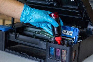 Technicians Refill ink cartridges, printer Inkjet colors.Printer Repairs and Maintenance inkjet or Laser printers concept ,selective focus