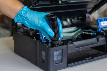 Technicians Refill ink cartridges, printer Inkjet colors.Printer Repairs and Maintenance inkjet or Laser printers concept ,selective focus