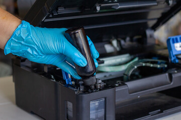Technicians Refill ink cartridges, printer Inkjet colors.Printer Repairs and Maintenance inkjet or Laser printers concept ,selective focus