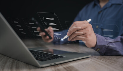 Concepts of practices and policies Company articles association forTerms and Conditions : Businessman using stylus pen to select electronic document on a digital document in a virtual screen to read.	