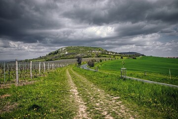 Dark clouds above the hill surrounded by vineyards near Klentnice, Czech republic