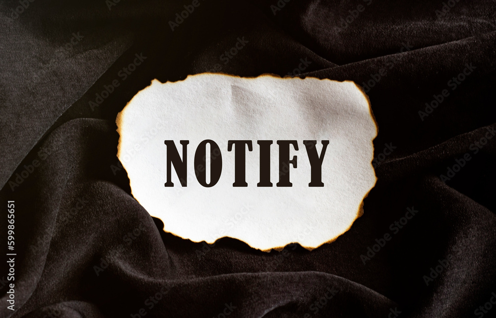 Poster burned paper on a black background with text notify