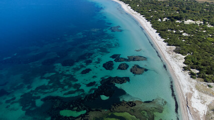 aerial view of the crystal clear sea waters of the beach of is solinas in southern sardinia
