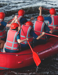 Red raft boat during whitewater rafting extreme water sports on water rapids, kayaking and canoeing...