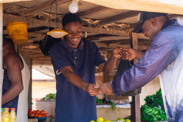 African man shopping from a grocery seller in a typical african market