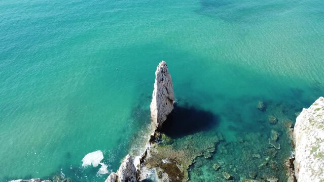 Nido dell'Aquila is one of the charatheristic faraglione of sardinian west coast and in the background the beautiful crystalline sea of ​​buggerru

