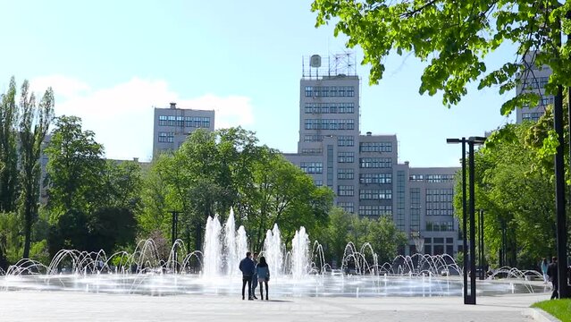 Derzhprom building with fountain and green park in spring on Freedom Square in Kharkiv city center. Travel destinations in Ukraine