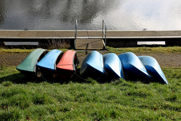 Canoes Lying on Grass Verge at a Canal Side Walkway