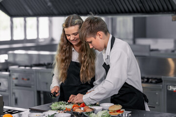 Teenagers learn from expert chefs at culinary school to prepare ingredients and create a variety of...