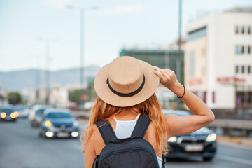 Fototapeta premium Happy beautiful young woman smiling in the city street - Delightful girl enjoying sunny day out - Healthy lifestyle concept with female laughing outside. 