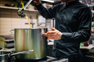 chef cooking soup on restaurant kitchen