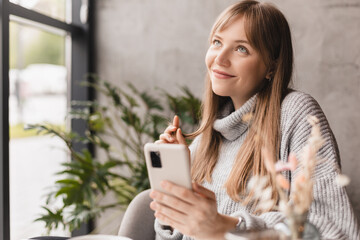 Portrait of sweet lovely romantic lady hold phone play curl look empty sitting in cafe, dreaming,...