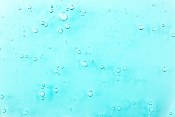 Cosmetic gel, serum transparent sample. Liquid cream with bubble texture. Gel texture of a cosmetic product. Clear liquid lotion for skin care.