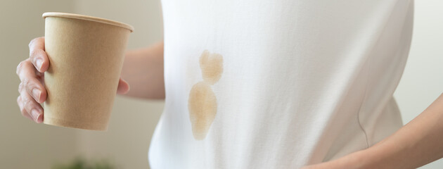 Clothes stain dirty from food concept, people get a coffee drop split from glass on the t-shirt.