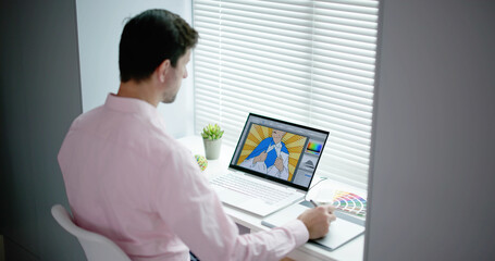 Male Designer Using Graphic Tablet While Working