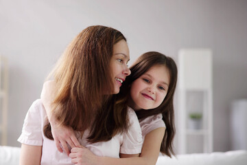 Happy Mom Embracing Smiling Child