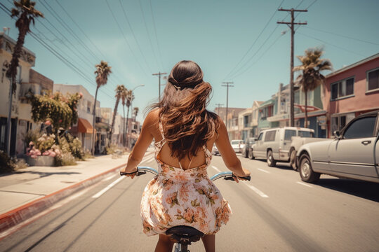 Back View of Beautiful Woman Cycling along Venice Beach - Generative Ai