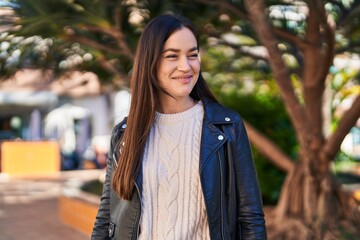 Fototapeta premium Young woman smiling confident standing at park