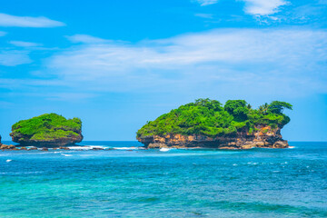 Fototapeta premium Beautiful Watukarung Beach in Pacitan, Indonesia with rocks on the ocean.