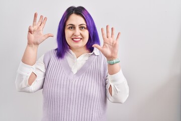 Plus size woman wit purple hair standing over white background showing and pointing up with fingers...