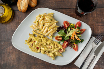 Grilled cubed chicken with pasta and salad