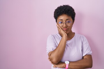 Young african american woman standing over pink background thinking looking tired and bored with...