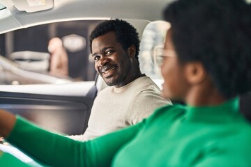 African american man and woman couple driving car at street