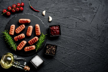grilled sausages on a stone background with copy space for your text