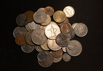 Many currency old coins on black background.