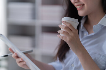 Fototapeta premium Young happy businesswoman working with tablet in office.