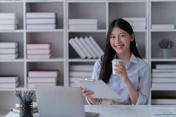 Young happy businesswoman working with tablet in office.