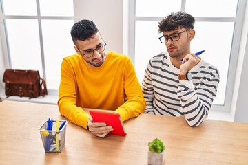 Two man business workers using touchpad working at office