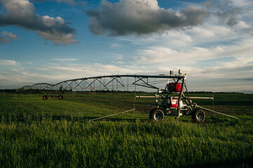 Watering in a large field using a self-propelled sprinkler system with a center swing.