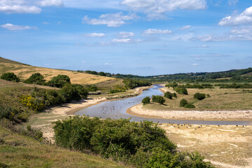 Low level water in Cuckmere river, East Sussex, England, in summer 2022 during a drought